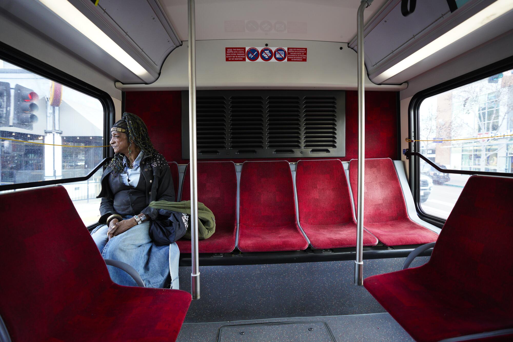 Raven Jones, 66, rides on a bus from her downtown San Diego apartment to St. Paul's Cathedral on Jan. 26.