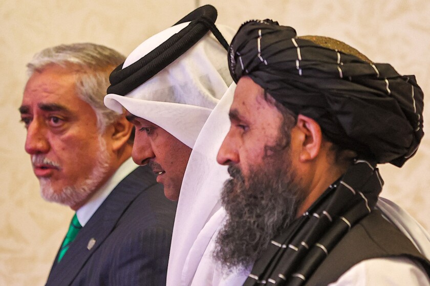Mullah Abdul Ghani Baradar with two other men