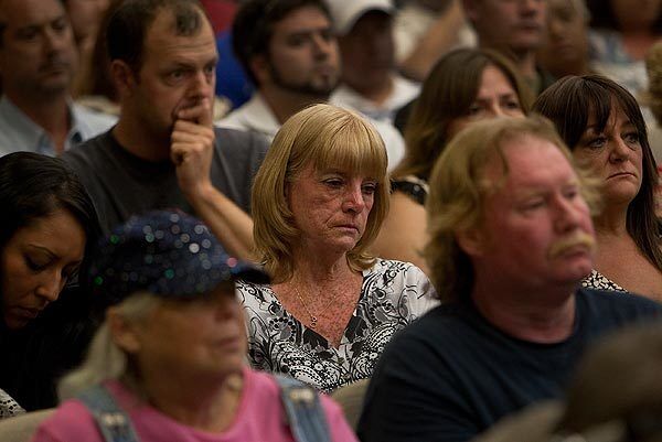 Cathy Thomas, mother of Kelly Thomas, listens to public comment during the Fullerton City Council meeting.