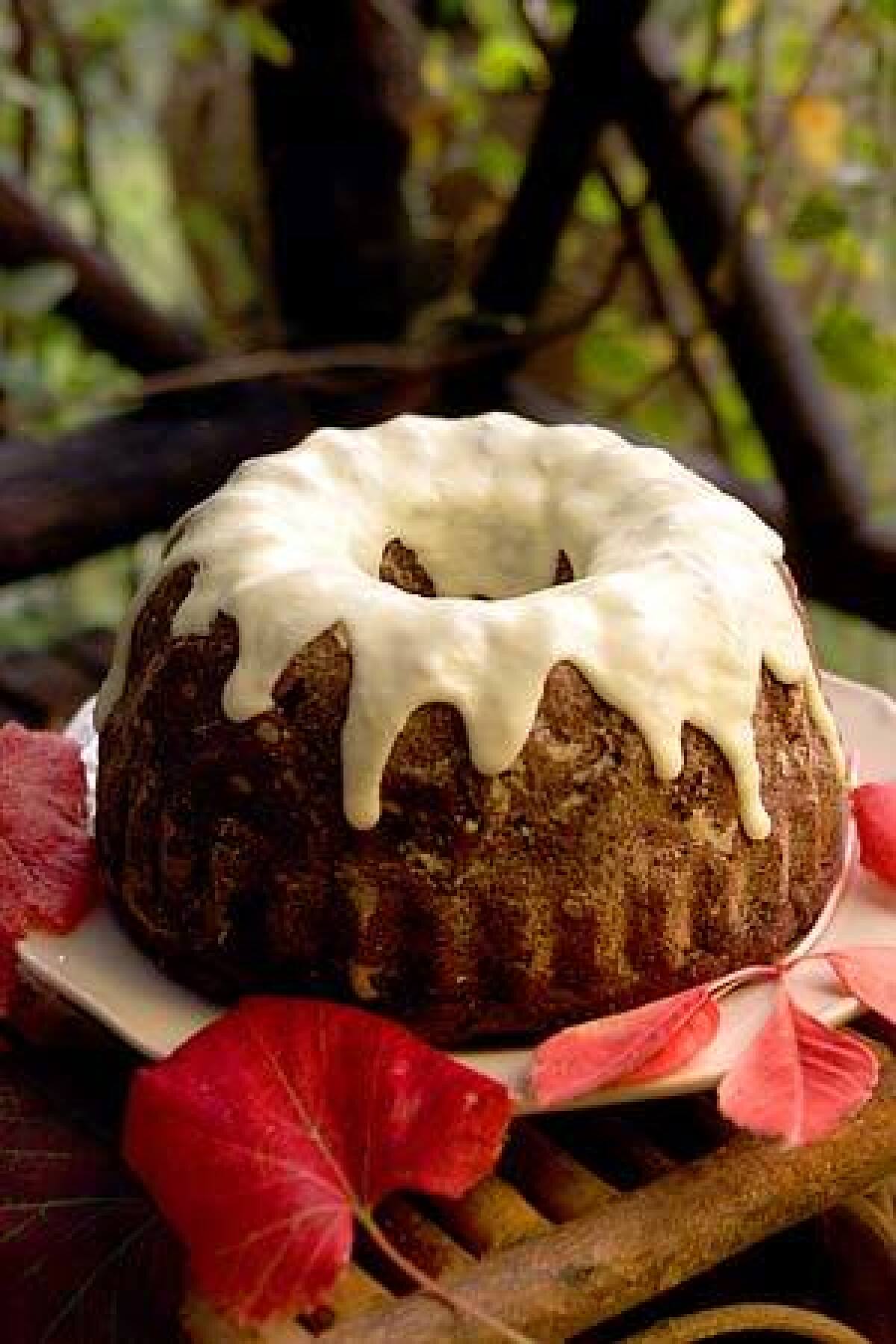 A thick rum orange icing tops persimmon cake, an inspired dessert for the fall holiday table.