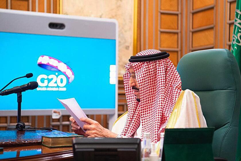FILE - In this March 26, 2020, file photo released by Saudi Press Agency, SPA, Saudi King Salman, chairs a video call of world leaders from the Group of 20 and other international bodies and organizations, from his office in Riyadh, Saudi Arabia. The Nov. 21-22, 2020, Group of 20 summit, hosted by Saudi Arabia, will be held online this year because of the coronavirus. The pandemic has offered the G-20 an opportunity to prove how such bodies can facilitate international cooperation in crises — but has also underscored their shortcomings. (Saudi Press Agency via AP, File)