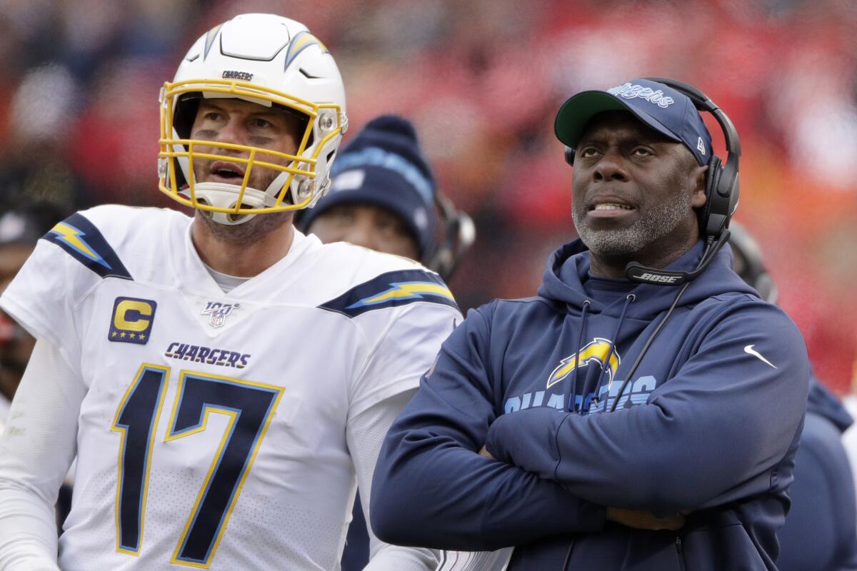 Chargers coach Anthony Lynn stands next to quarterback Philip Rivers during a game Dec. 29, 2019.