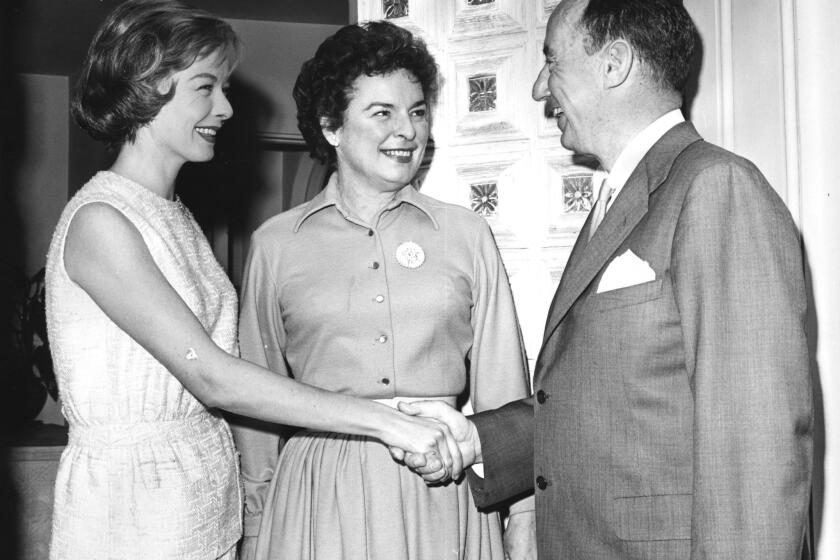 Diana Lynn, left, and Mercedes McCambridge greet Adlai E. Stevenson at Miss Lynn's Beverly Hills home.