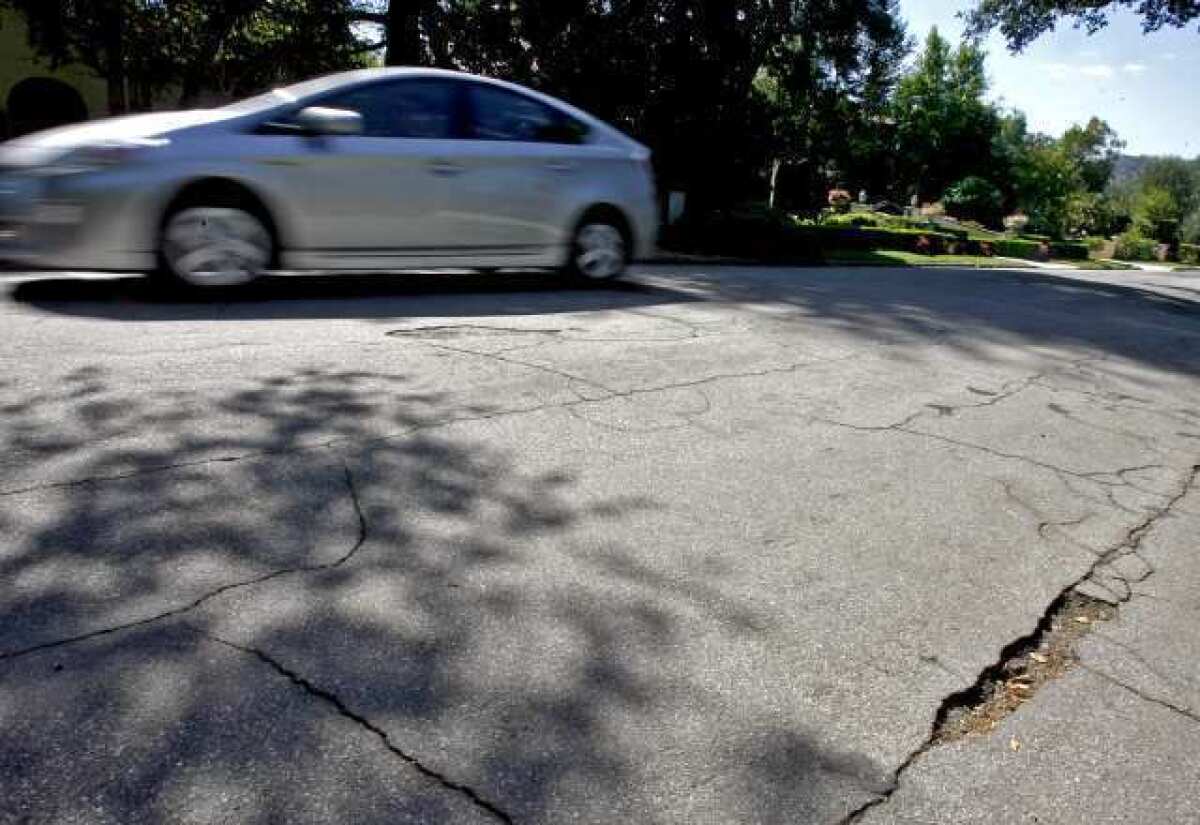 The road on the 4400 block of Woodleigh is cracked and has potholes.