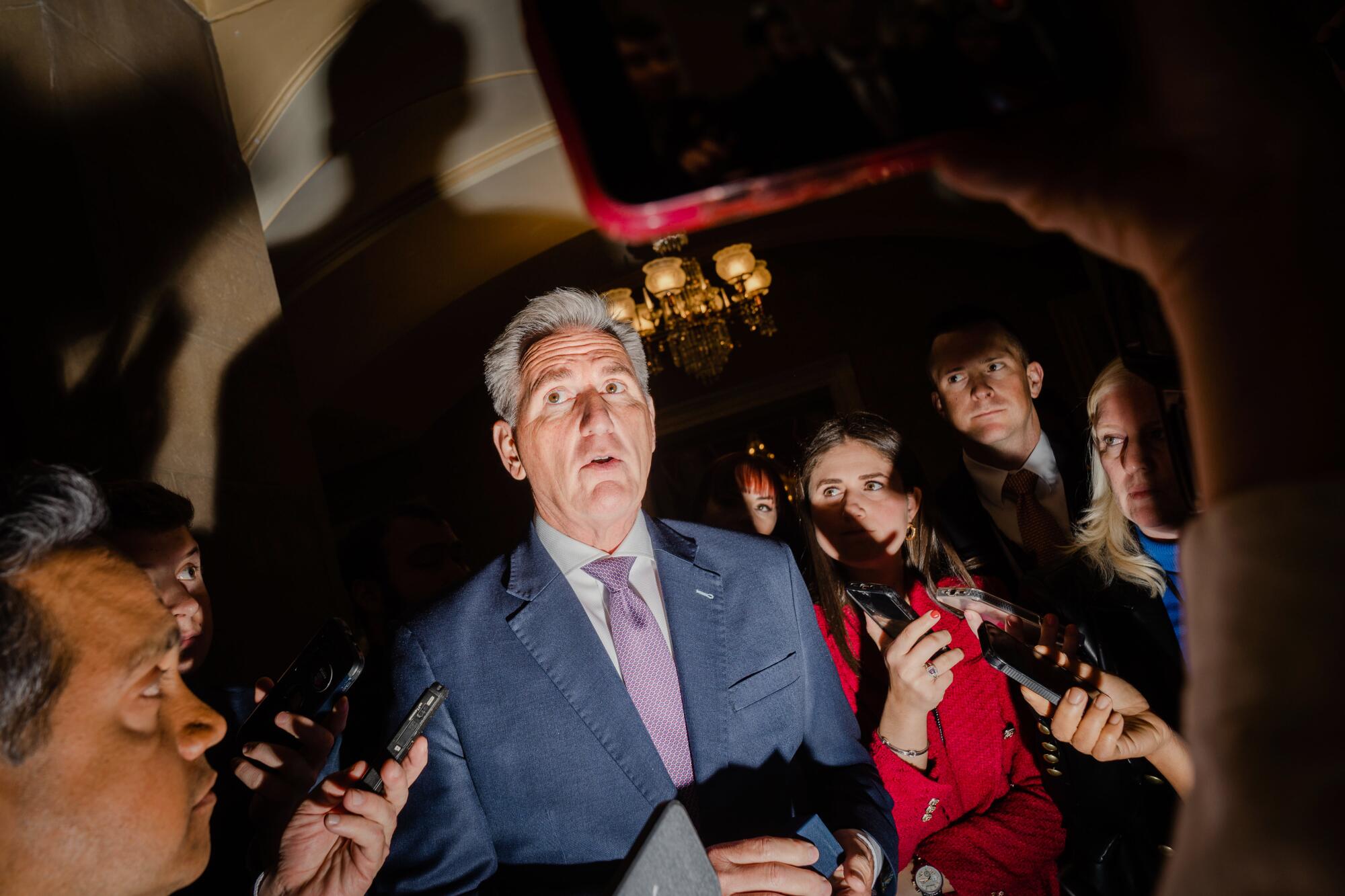 House Speaker Kevin McCarthy surrounded by reporters 
