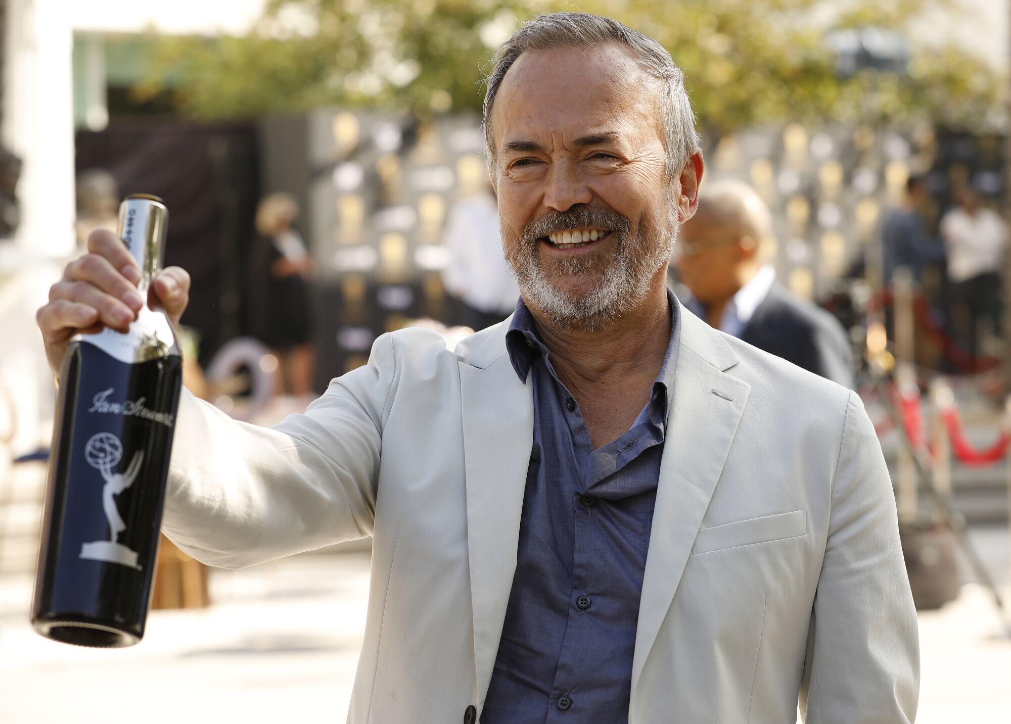 73rd Emmy Awards executive producer Ian Stewart holds a bottle of Sterling Vineyards wine.