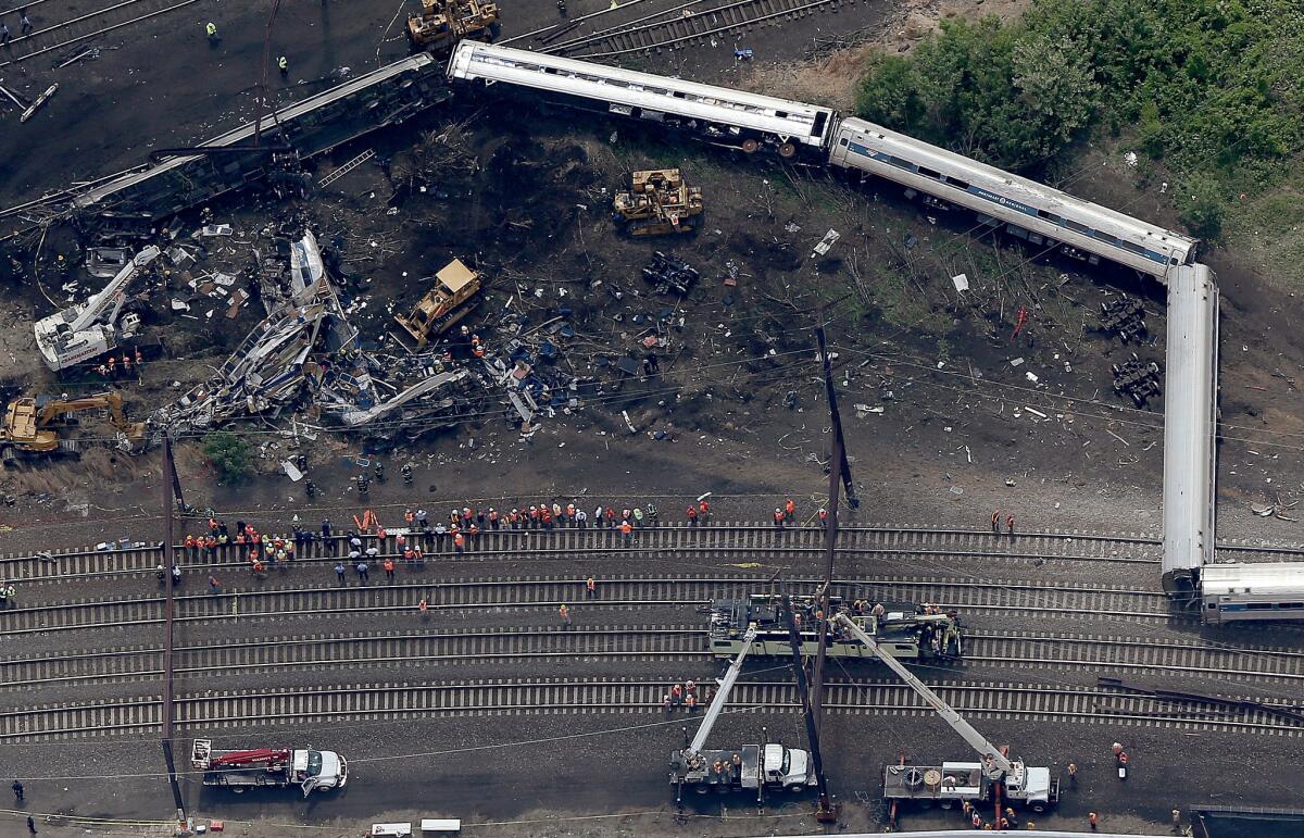 Investigators and first responders work near the wreckage of Amtrak Northeast Regional Train 188, from Washington to New York, that derailed Tuesday in north Philadelphia.