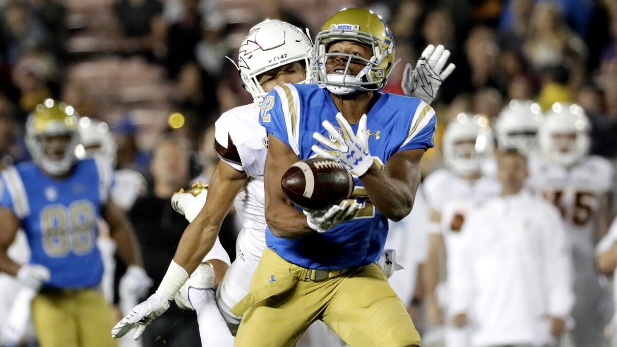 UCLA's Eldridge Massington drops this long pass after beating ASU defensive back Chase Lucas deep in the second quarter Saturday, but he did pull off a 39-yard run on a reverse on the second play of the game.