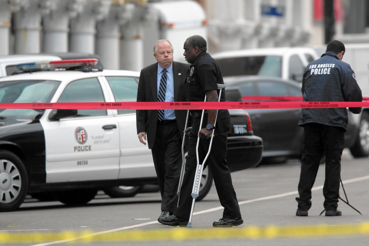 L.A. Police Officer Clifford Proctor walks on crutches in Venice at the scene where he fatally shot Brendon K. Glenn, an unarmed homeless man, in May.