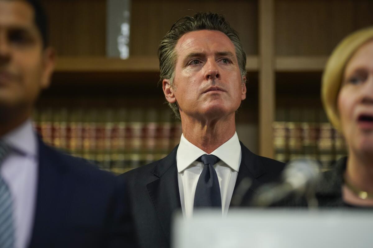 Gov. Gavin Newsom listens during a press conference in Los Angeles on Wednesday.