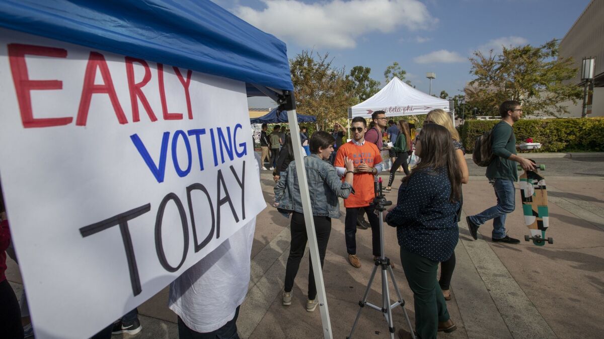 Democrats encourage voters to cast their ballot for the 2018 midterm elections at the early voting center at the University of California Irvine campus in Irvine, Calif. on Oct. 30.
