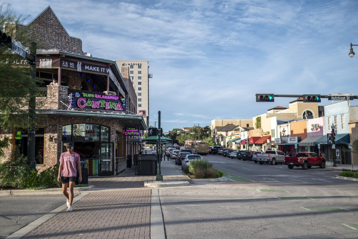People walk through downtown in San Marcos, Texas.