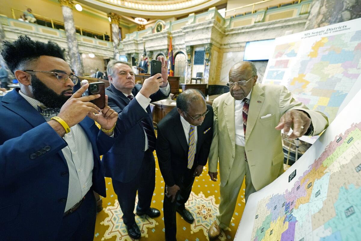 Mississippi lawmakers look at a map.