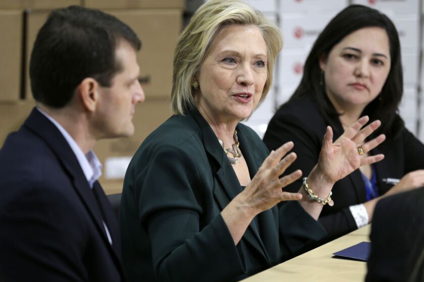 Democratic presidential candidate Hillary Clinton, center, speaks during a small business roundtable Wednesday in Norwalk, Iowa.