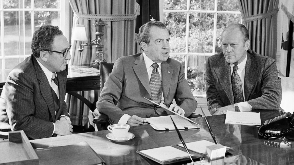 President Richard Nixon, center, meets with Henry Kissinger, left, and Vice President Gerald Ford in 1973. He resigned from office about 10 months later.