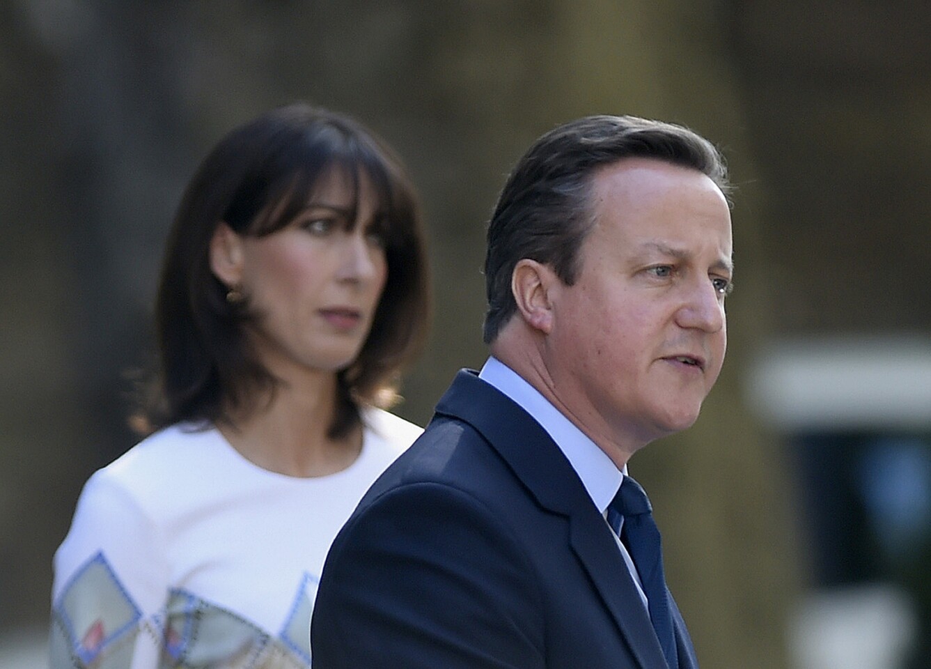Britain's Prime Minister David Cameron speaks outside 10 Downing Street as his wife Samantha looks on Friday.