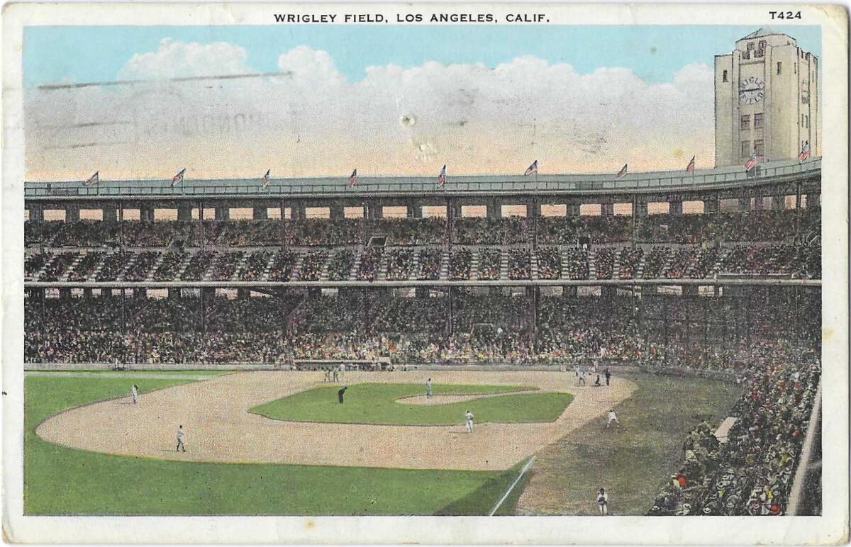 An interior view of L.A.'s Wrigley Field shows packed stands, players on the field and the stadium clock tower.