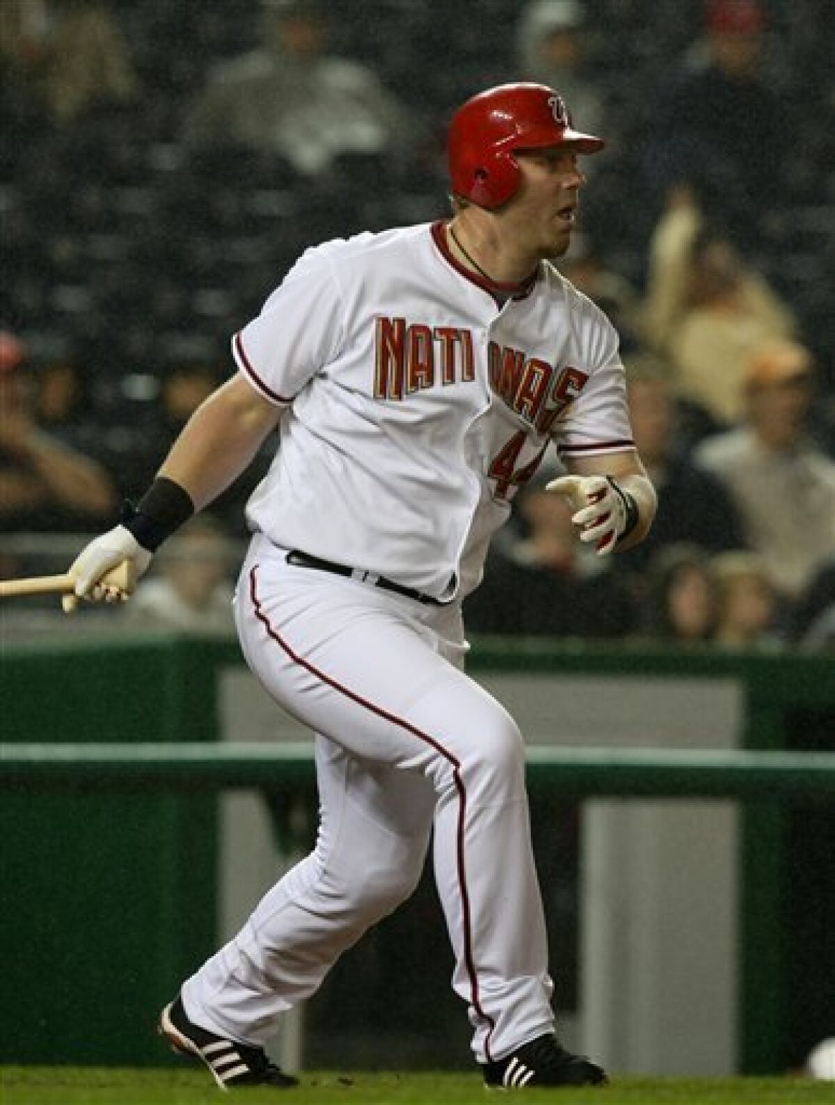 Washington Nationals' Adam Dunn follows through on a two-run RBI single against the Houston Astros during the sixth inning of a baseball game in Washington on Monday, May 4, 2009. (AP Photo/Luis M. Alvarez