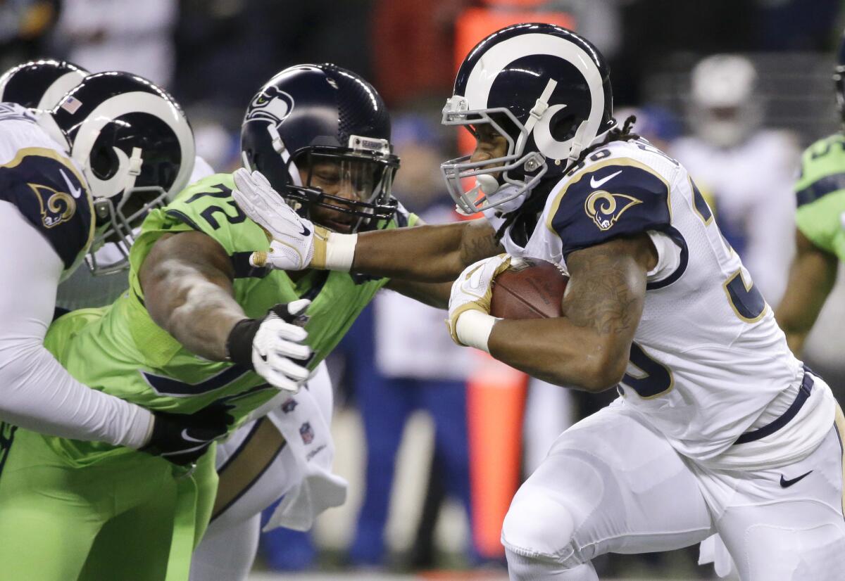 Rams running back Todd Gurley, right, tries to fend off Seahawks defensive end Michael Bennett (72) in a Dec. 15 game in Seattle.