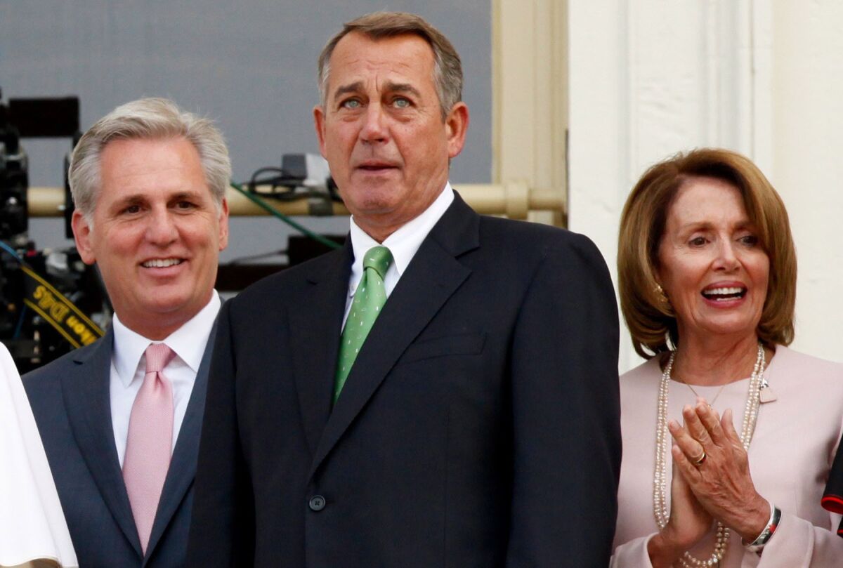 Speaker of the House John Boehner is flanked by House Majority Leader Kevin McCarthy and House Democratic Leader Rep. Nancy Pelosi the balcony of the US Capitol building during an event with Pope Francis.
