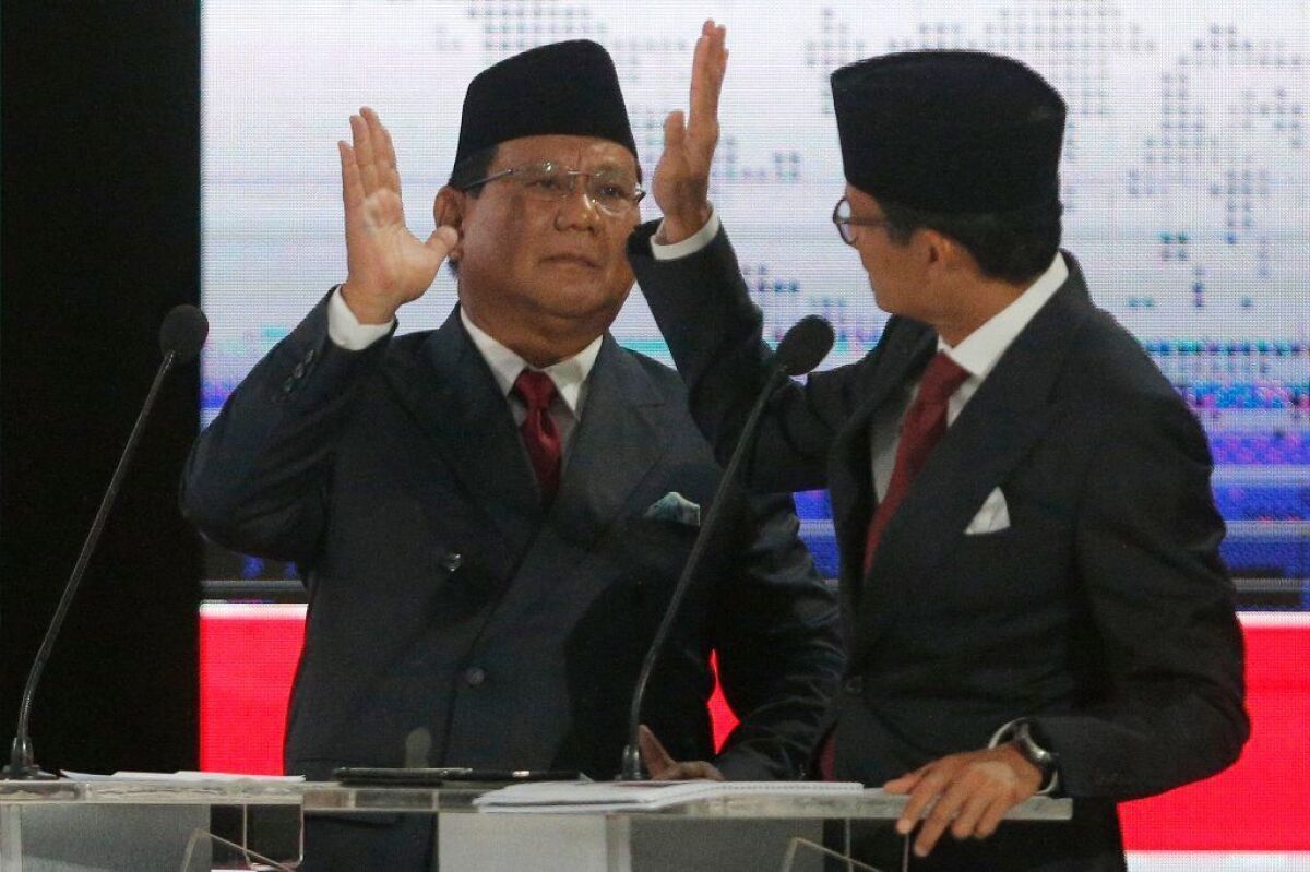 Indonesian presidential candidate Prabowo Subianto, left, and running mate Sandiaga Uno take part in a televised debate April 13, 2019.