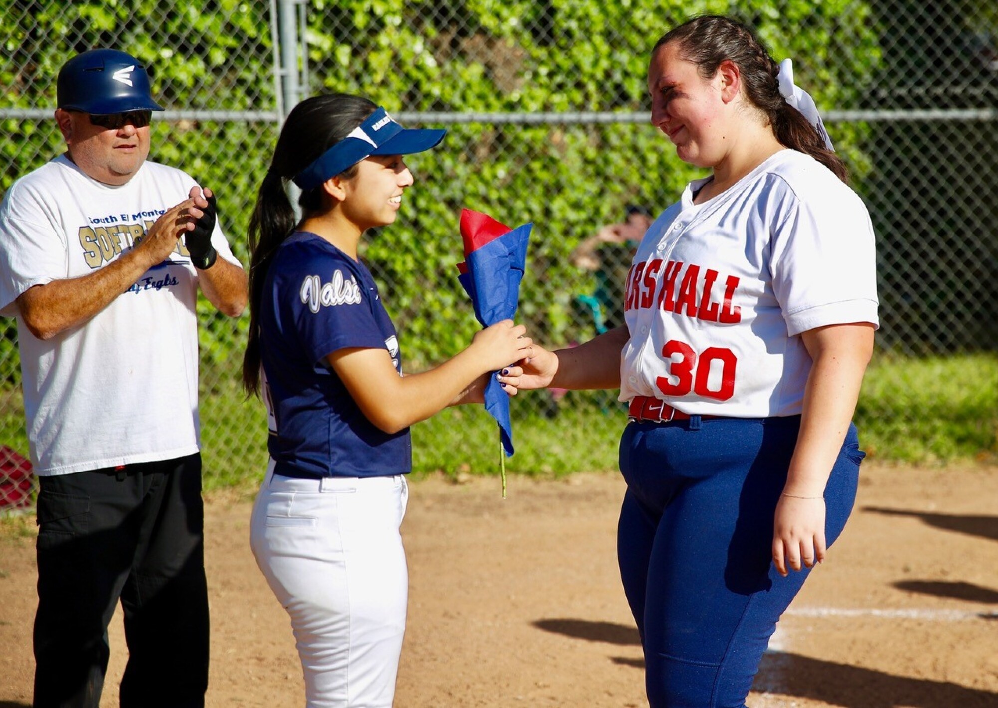 Marshall senior MP Rosie Agdaian presents South El Monte senior with a rose before her final home game.