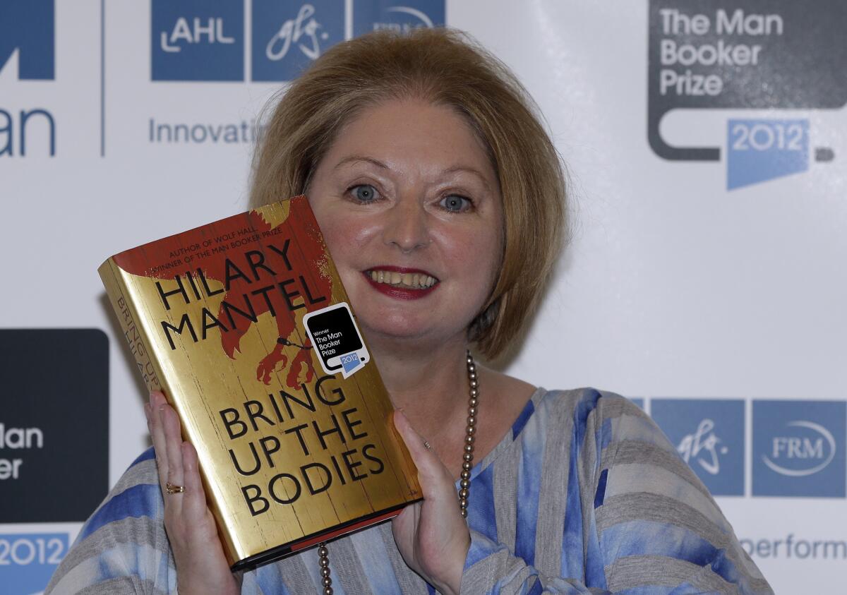 Author Hilary Mantel holding up one of her novels