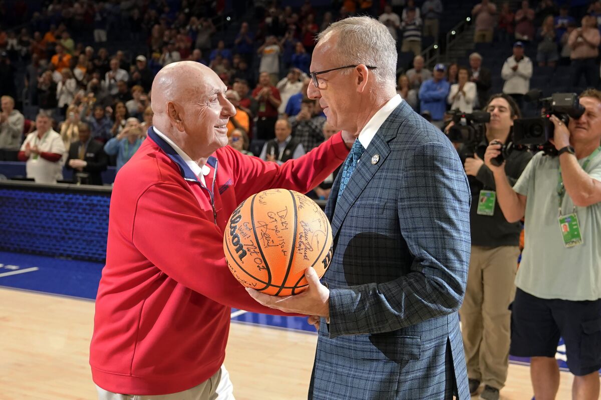 ESPN broadcaster Dick Vitale, left, meets with SEC commissioner Greg Stankey before an NCAA college basketball between Texas A&M and Arkansas at the Southeastern Conference tournament, Saturday, March 12, 2022, in Tampa, Fla. (AP Photo/Chris O'Meara)