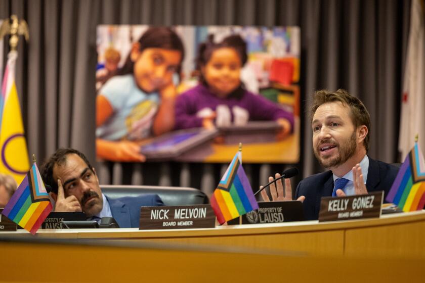 Los Angeles, CA - June 18: LAUSD executive officer Michael McLean, left, listens as board member Nick Melvoin, right, comments prior to the board's vote on a Melvoin sponsored resolution to create truly phone-free school days across the district on Tuesday, June 18, 2024 in Los Angeles, CA. (Brian van der Brug / Los Angeles Times)