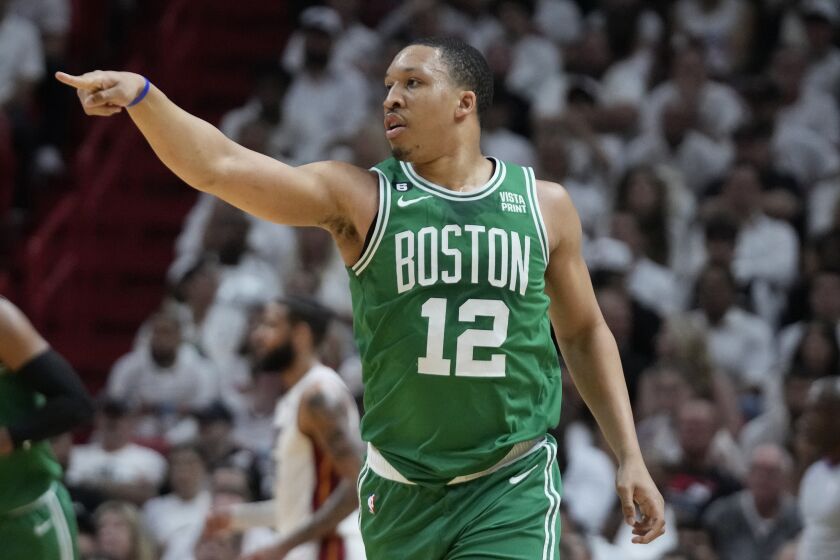 Boston Celtics forward Grant Williams (12) gestures to his teammates during the first half of Game 4 during the NBA basketball playoffs Eastern Conference finals against the Miami Heat, Tuesday, May 23, 2023, in Miami. (AP Photo/Wilfredo Lee)