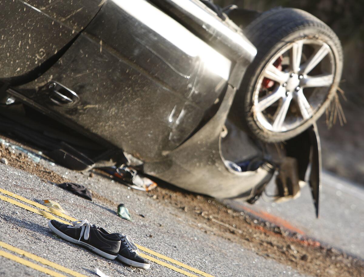 Vander Brug, Brian –– – 136164.ME.0409.malibuTC.BRV –– A pair of tennis shoes at scene where a 17–year–old driver was killed and three other teens injured in a single–car rollover accident at 32020 Pacific Coast Hwy. in Malibu at around 10:20 pm Tuesday evening April 8 2008. Photographed Wednesday morning April 9 2008.