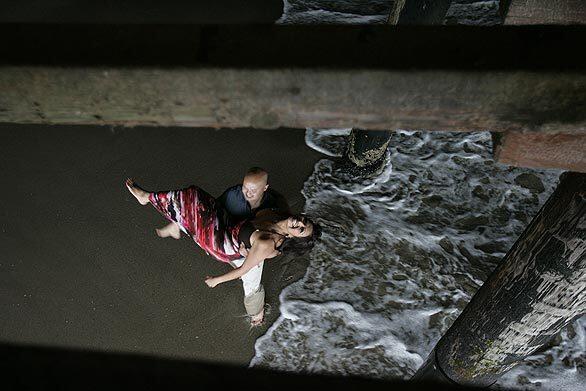 Matt Phuot carries his fiancee, Ida Sweetwater, under the Santa Monica Pier. They are to be married in October and were at the pier to have their engagement photo taken.