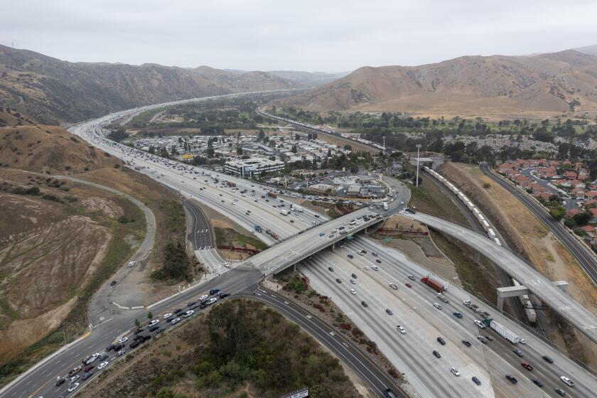 CORONA, CA - May 20: An aerial view of traffic on the 91 Freeway and the Green River Rd. overpass where there have been more than a dozen instances of cars having their windows shot out by bebe guns. Photo taken Thursday, May 20, 2021 in Corona, CA. At least four vehicles were shot at in Anaheim Thursday morning near the WB 91 Freeway. The windows of three cars were shot out on the 91 Freeway in Corona recently, the latest in a string of dozens of similar incidents, according to the California Highway Patrol. The CHP is now investigating roughly 50 shooting incidents that began in late April and have targeted cars traveling on the freeway in Riverside, Orange and Los Angeles counties. (Allen J. Schaben / Los Angeles Times)