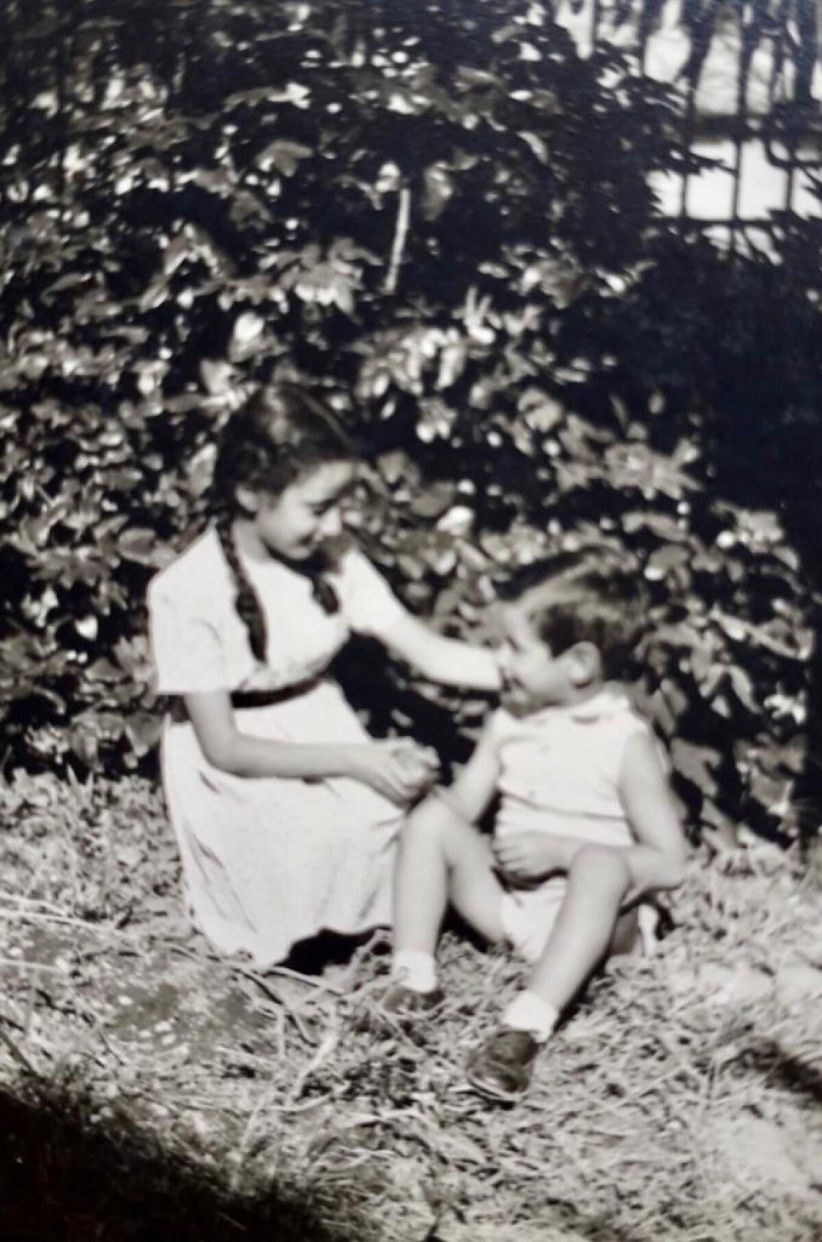 Elisa Andreoni and her brother Gianni Marchesi play in the public gardens near Porta Venezia in Milan, Italy, in 1941