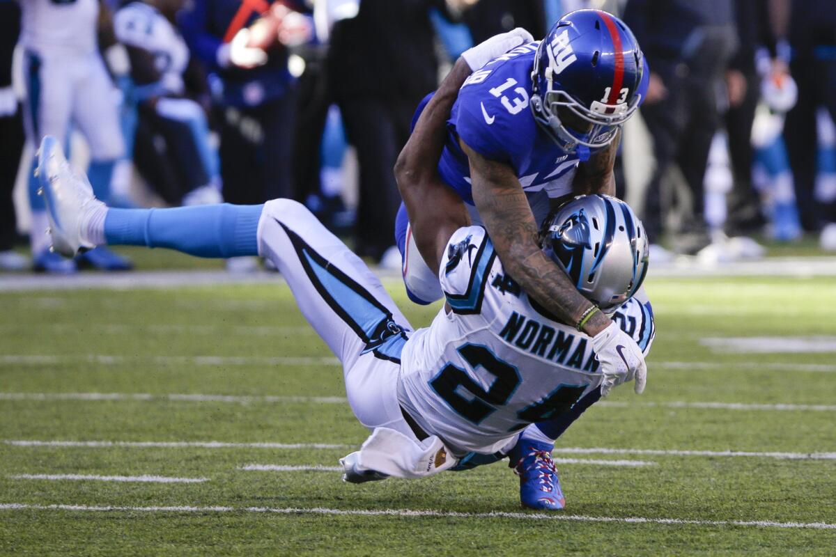 Giants wide receiver Odell Beckham (13) goes after Panthers defensive back Josh Norman (24) during the first half.