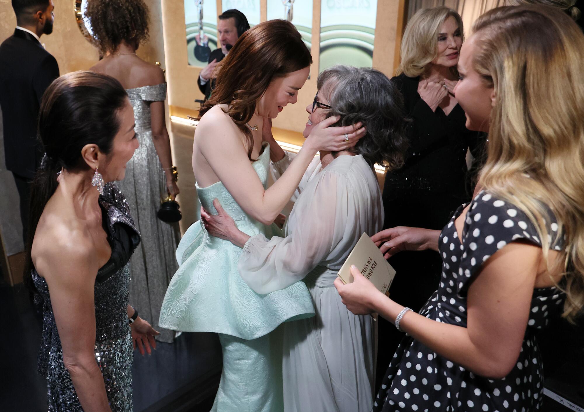 Emma Stone meets with Sally Field backstage after winning best actress.