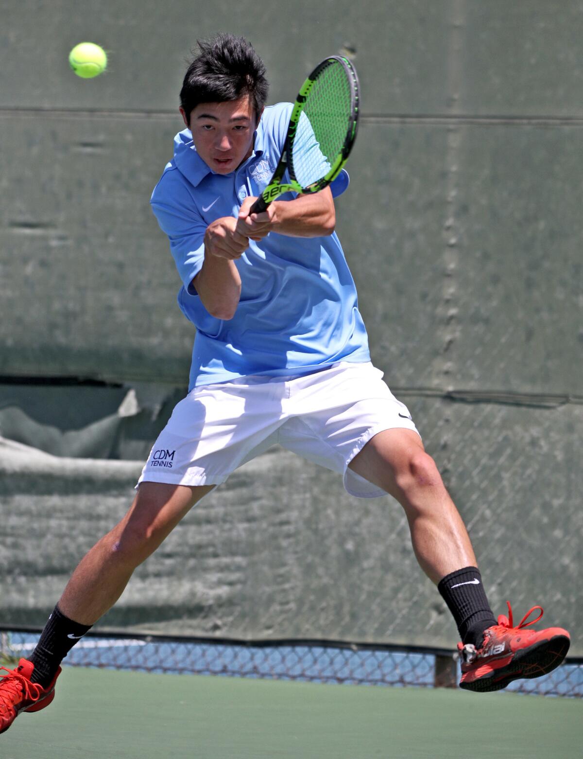 Corona del Mar's Kyle Pham returns the ball in the round of 16 singles match in the CIF Southern Section Individuals tournament against Sage Hill's Emin Torlic at Seal Beach Tennis Center on Wednesday.