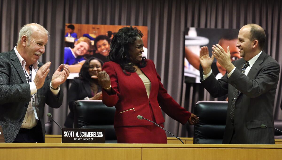 Michelle King, center, receives applause from L.A. Unified board member Scott Schmerelson, left, and board President Steve Zimmer after being named on Monday as the district's new superintendent.