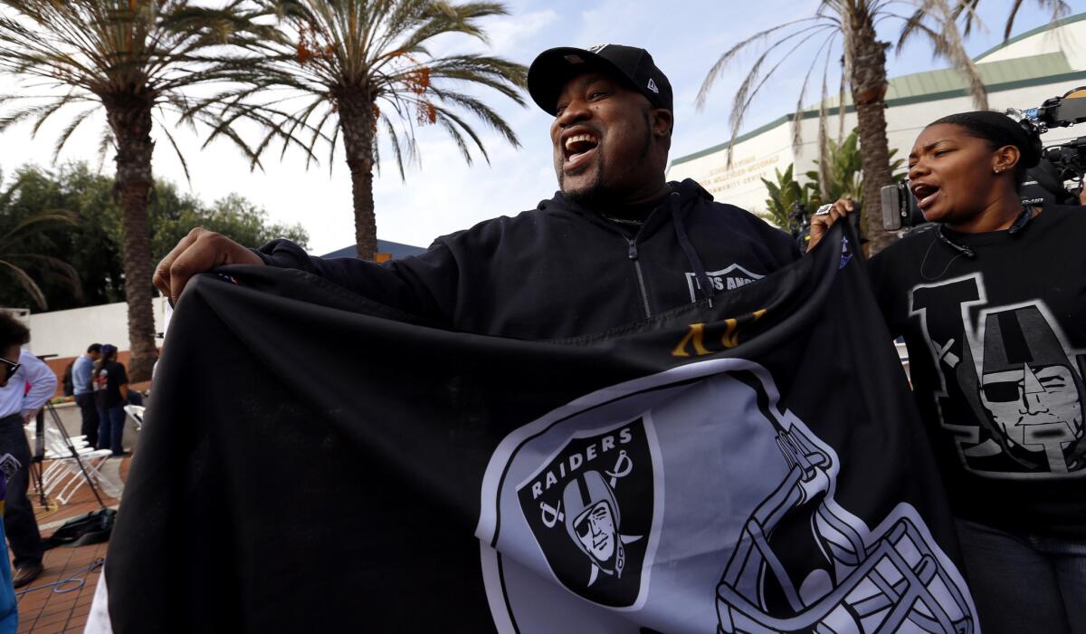 Raiders fan Tyrone Butterfield, 45, of Long Beach cheers following a news conference that officially announced the plan for the San Diego Chargers and Oakland Raiders to build an NFL stadium in Carson.