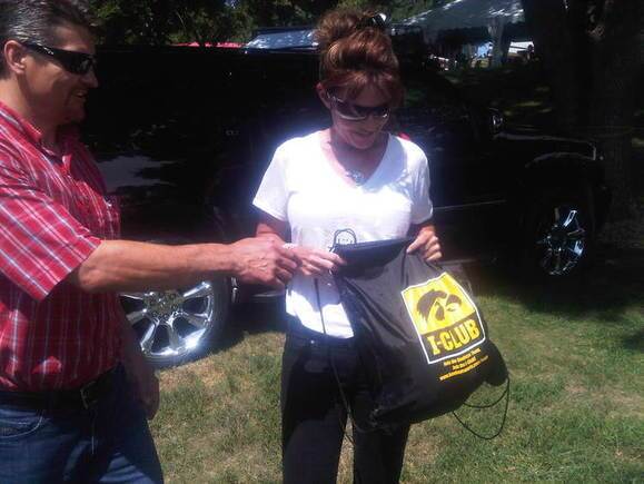 Palin inspects a bag handed to her by a supporter at the Iowa State Fair Friday.