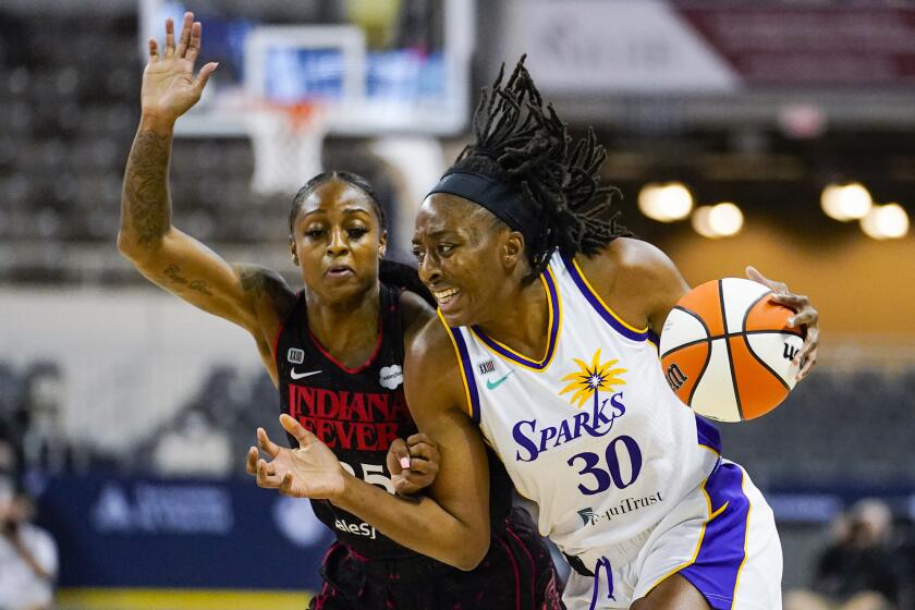 Los Angeles Sparks forward Nneka Ogwumike (30) drives on Indiana Fever guard Tiffany Mitchell (25) during the first half of a WNBA basketball game in Indianapolis, Tuesday, Aug. 31, 2021. (AP Photo/Michael Conroy)