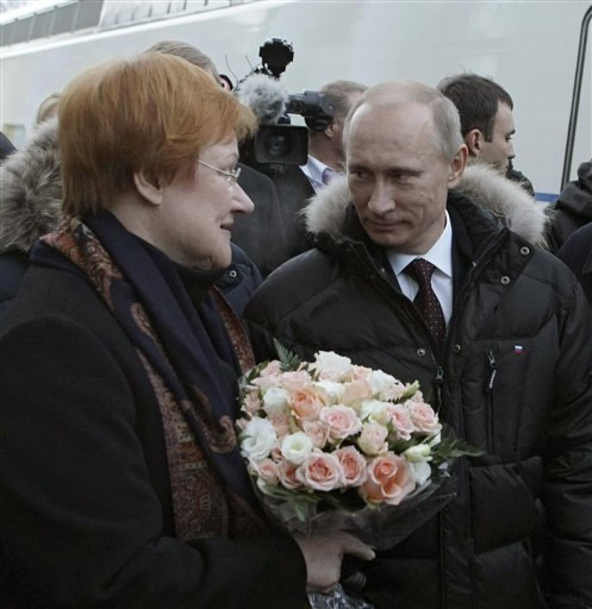 Russian Prime Minister Vladimir Putin, right, meets Finland's President Tarja Halonen who arrived by new high speed train in Vyborg, some 160 km (100 miles) west of St. Petersburg, Sunday Dec. 12, 2010. Halonen and Putin inaugurated the first high-speed rail link between the EU and Russia as new trains start running between Helsinki and St. Petersburg, shortening travel time by nearly half, boosting business travel and tourism. (AP Photo/RIA Novosti, Alexei Nikolsky, Pool)