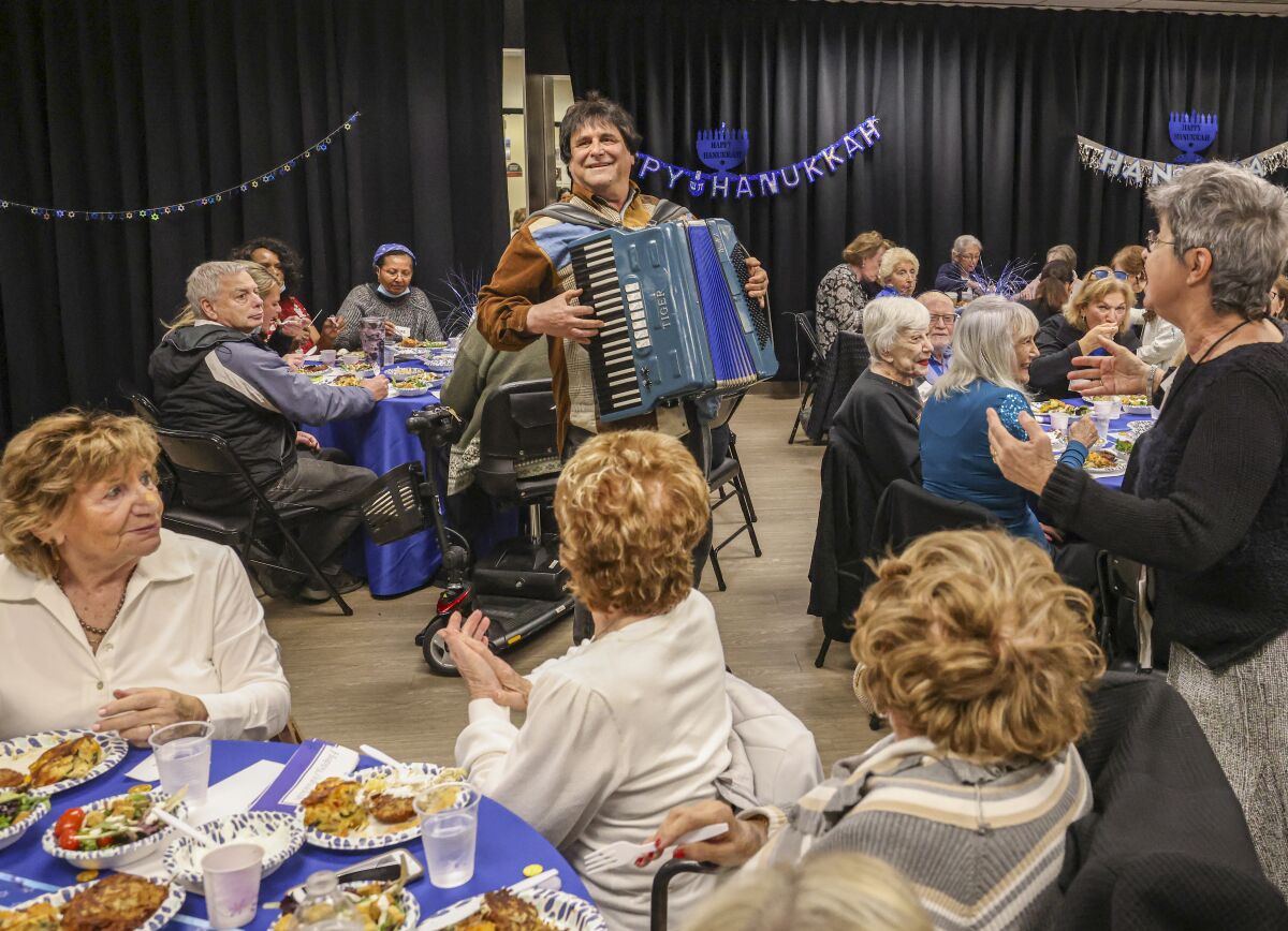 An accordionist entertains the crowd at a Hanukkah celebration at The Lawrence Family Jewish Community Center in La Jolla.