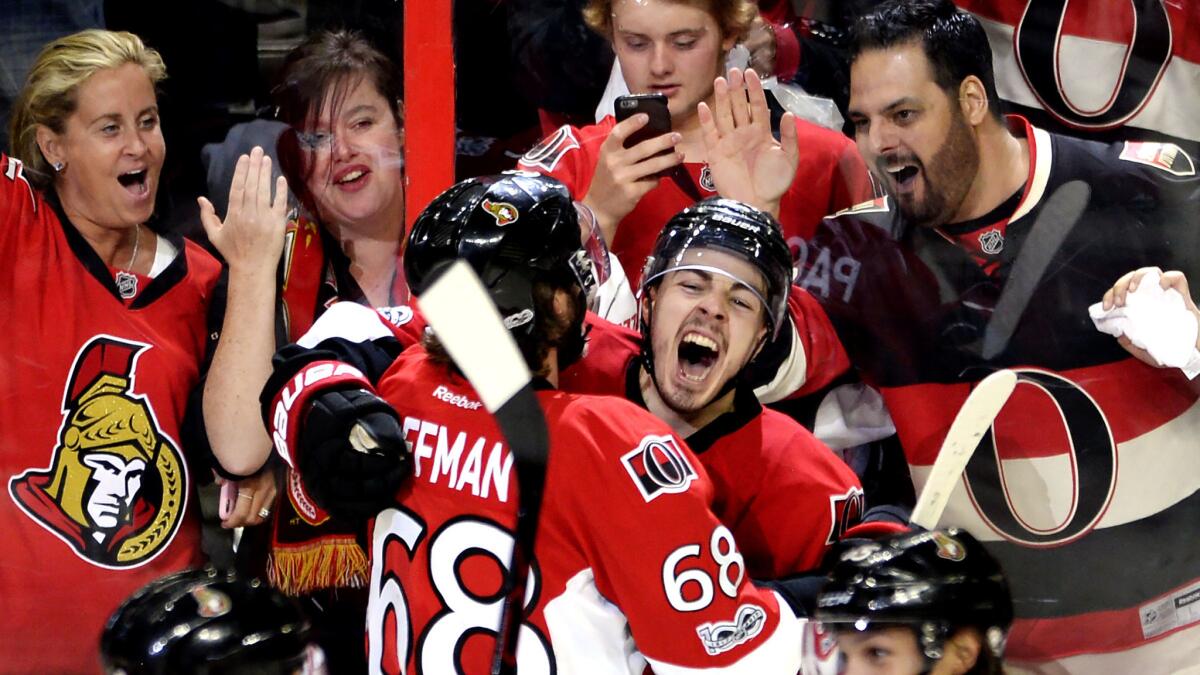 Senators center Jean-Gabriel Pageau celebrates his game-winning goal against the Rangers with left wing Mike Hoffman (68) on Saturday.