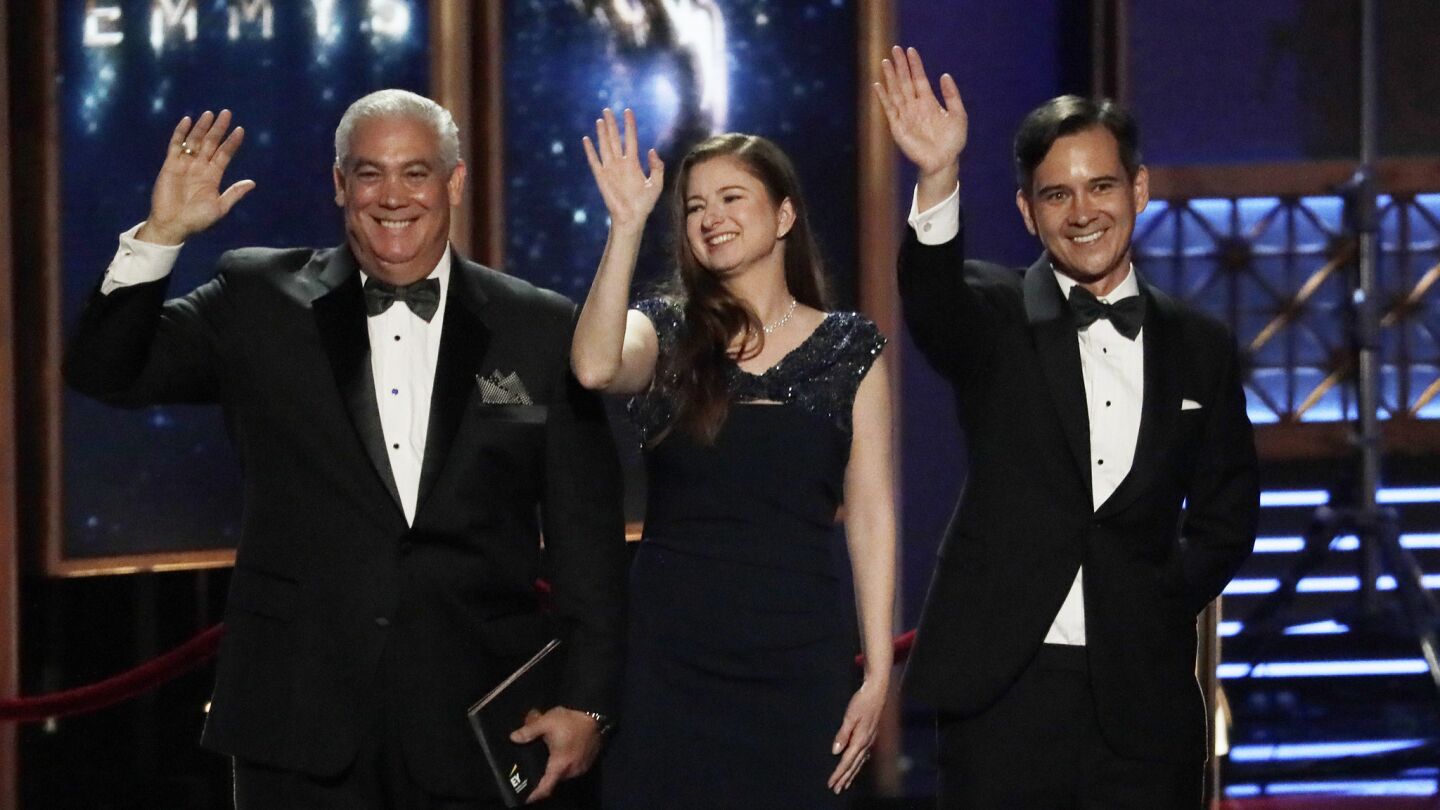 Ernst & Young representatives appear onstage during the 69th Emmy Awards.