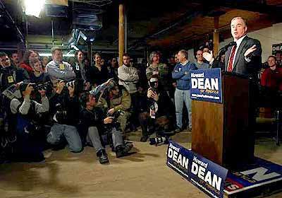 Howard Dean addresses the media during a stop at his campaign headquarters in Manchester, N.H.