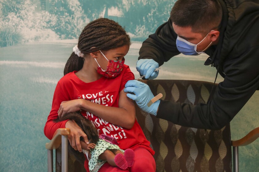 A child receives a COVID-19 vaccine shot 