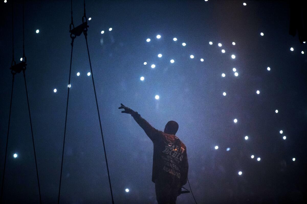 Kanye West performs on a floating stage for his 'Saint Pablo' tour at The Forum in Inglewood, Calif., on Oct. 25, 2016