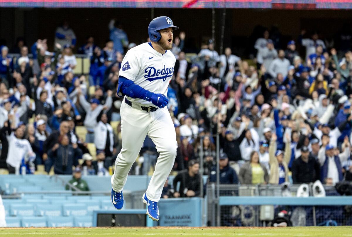 Dodgers third baseman Max Muncy celebrates after hitting a two-run home run