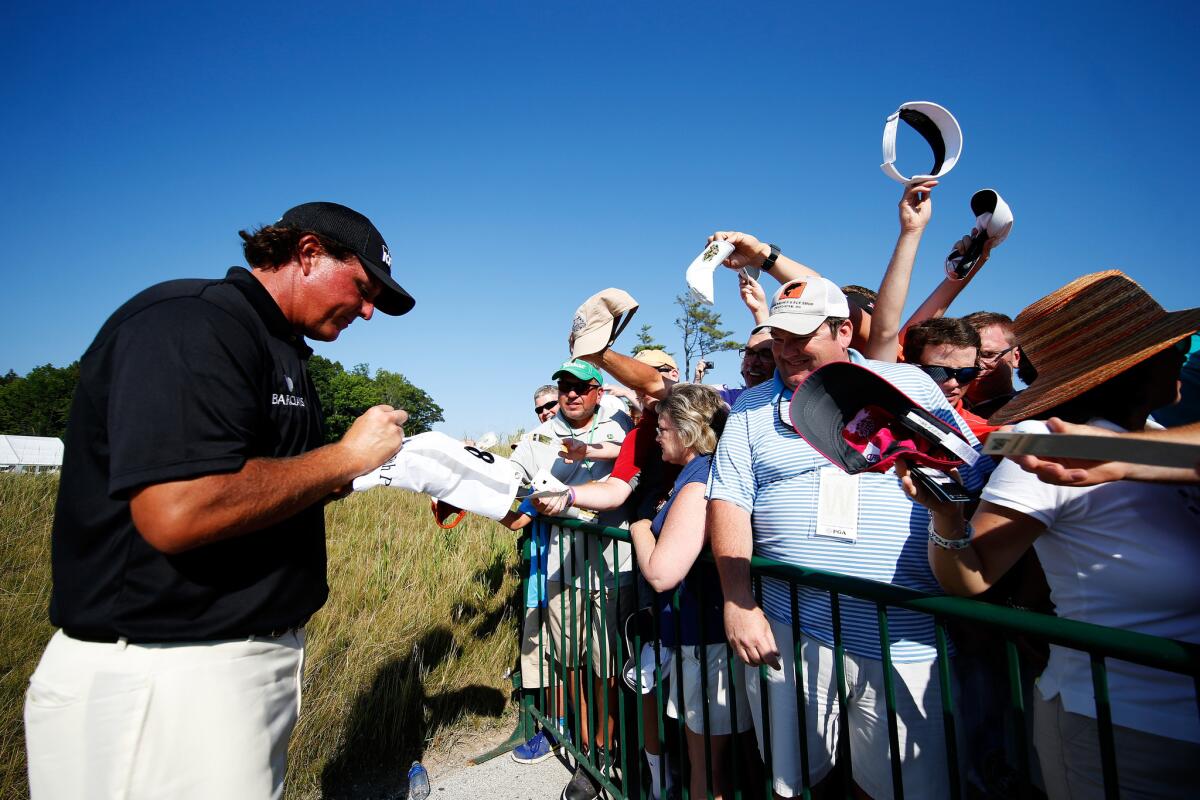 Phil Mickelson signs autographs for fans Saturday during the third round of the PGA Championship at Whistling Straits.